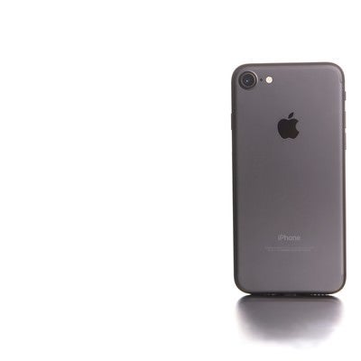 白い光に包まれたスマートフォンの写真